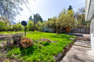 View of yard featuring fence