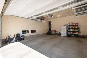 Nice spacious garage with storage racks above