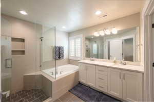 Bathroom in primary suite, double sinks, shower and separate garden tub