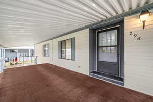 View of exterior entry featuring covered porch