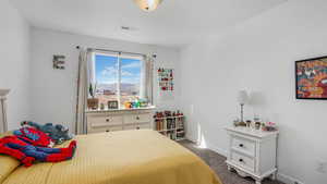 Bedroom featuring a mountain view, dark carpet, baseboards, and visible vents