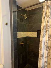Full bathroom featuring tiled shower