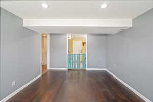 Finished basement with hardwood / wood-style floors, baseboards, and recessed lighting