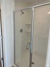 Full bath featuring a shower stall