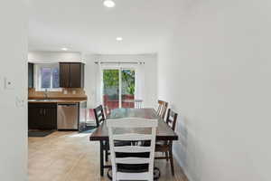 Dining area featuring recessed lighting and light tile patterned floors