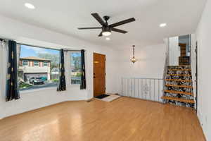 Interior space featuring baseboards, a ceiling fan, wood finished floors, and recessed lighting