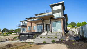 Contemporary home with multiple balconies and panoramic views of the Salt Lake Valley