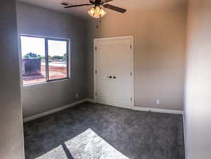 Unfurnished bedroom with carpet floors, a closet, baseboards, and visible vents