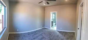 Spare room with a ceiling fan, baseboards, and carpet floors