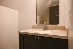 Bathroom with vaulted ceiling and vanity