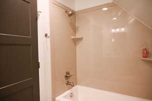 Bathroom featuring washtub / shower combination