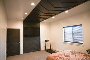 Carpeted bedroom with baseboards and recessed lighting