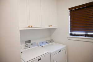 Laundry room with cabinet space and washer and dryer