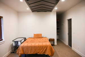 Carpeted bedroom with baseboards and recessed lighting