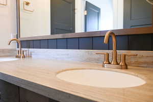 Bathroom featuring a sink and double vanity