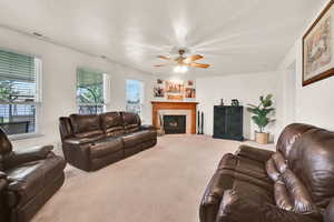 Family room with gas fireplace and ceiling fan