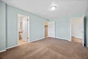 Unfurnished bedroom featuring baseboards, visible vents, and carpet floors