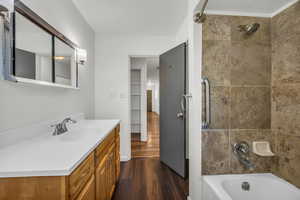Bathroom featuring bathtub / shower combination, wood finished floors, and vanity