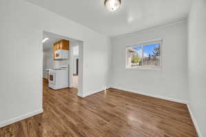 Unfurnished room with baseboards and wood finished floors