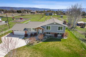View of front facade featuring fence, a chimney, and a mountain view