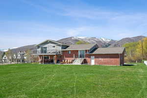 Back of property with brick siding and a mountain view