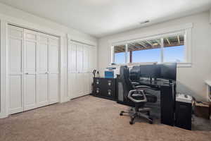 Office with carpet flooring and visible vents