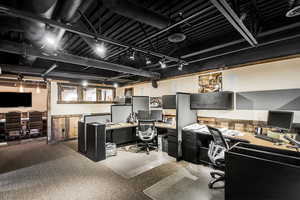 Carpeted home office featuring visible vents