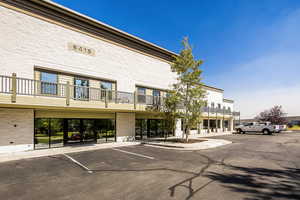View of property with uncovered parking