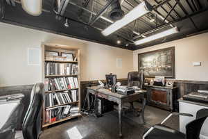 Office space featuring a wainscoted wall and carpet flooring