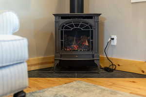 Interior details with a gas stove and wood finished floors
