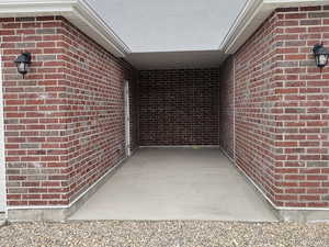 Doorway to property featuring brick siding
