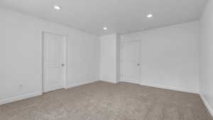 Spare room featuring baseboards, carpet flooring, and recessed lighting