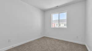 Unfurnished room featuring baseboards, carpet flooring, and visible vents