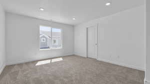 Unfurnished room featuring visible vents, baseboards, carpet flooring, and recessed lighting
