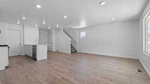 Kitchen featuring stainless steel dishwasher, visible vents, recessed lighting, and light wood-style floors