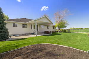 Rear view of house, with patio area,