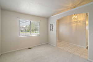 Entry den, arched walkways, and inviting chandelier