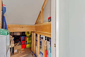 Large concrete floor storage area beneath the front room. Accessed through a full size door in the basement living room.