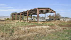 View of yard featuring a carport and fence