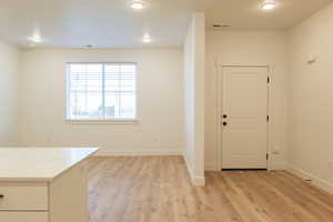 Foyer featuring recessed lighting, baseboards, visible vents, and light wood-style flooring