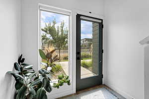 Entryway with wood finished floors and baseboards