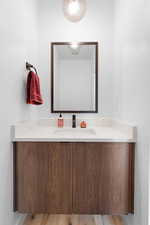 Bathroom featuring vanity and wood finished floors