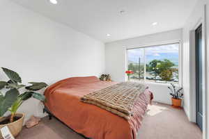 Bedroom featuring light carpet and recessed lighting