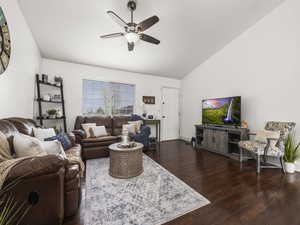 Living room with vaulted ceiling, wood finished floors, and ceiling fan