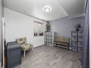 Living area featuring baseboards and wood finished floors