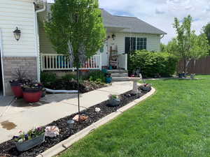 Exterior space featuring a lawn and a shingled roof
