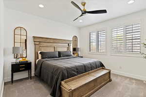 Carpeted bedroom with baseboards, recessed lighting, and ceiling fan