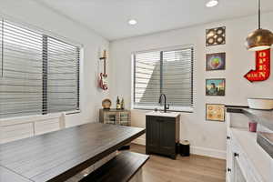 Dining space with light wood-style flooring, baseboards, and recessed lighting