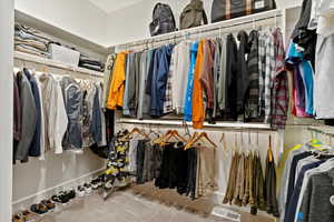 Spacious closet with carpet flooring and visible vents