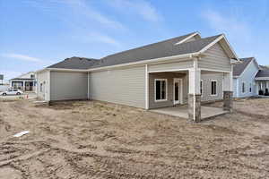 Rear of home with covered patio